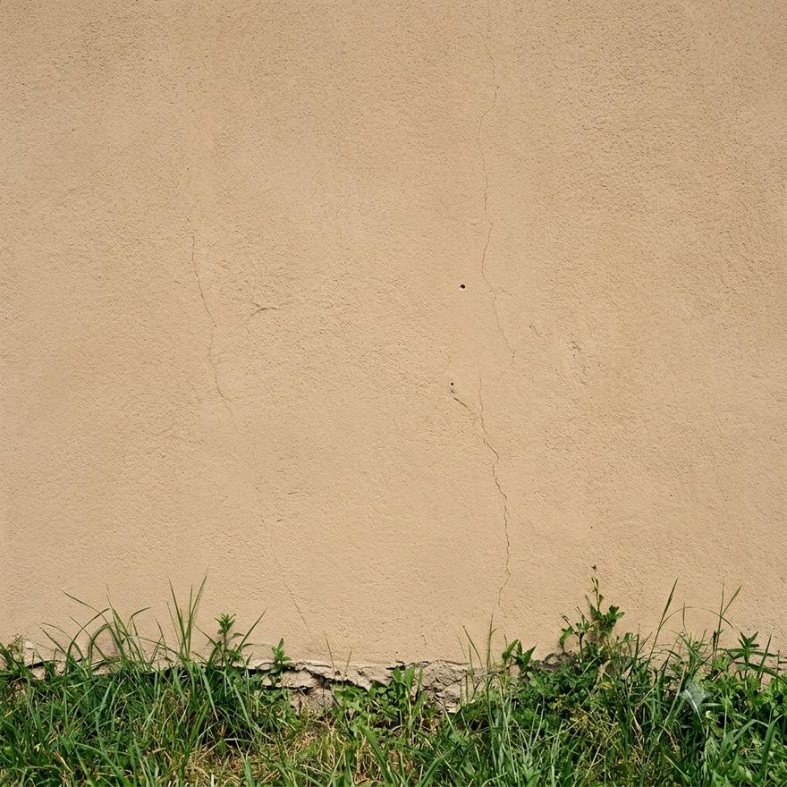 The same stucco wall after soft washing, rust and algae fully removed
